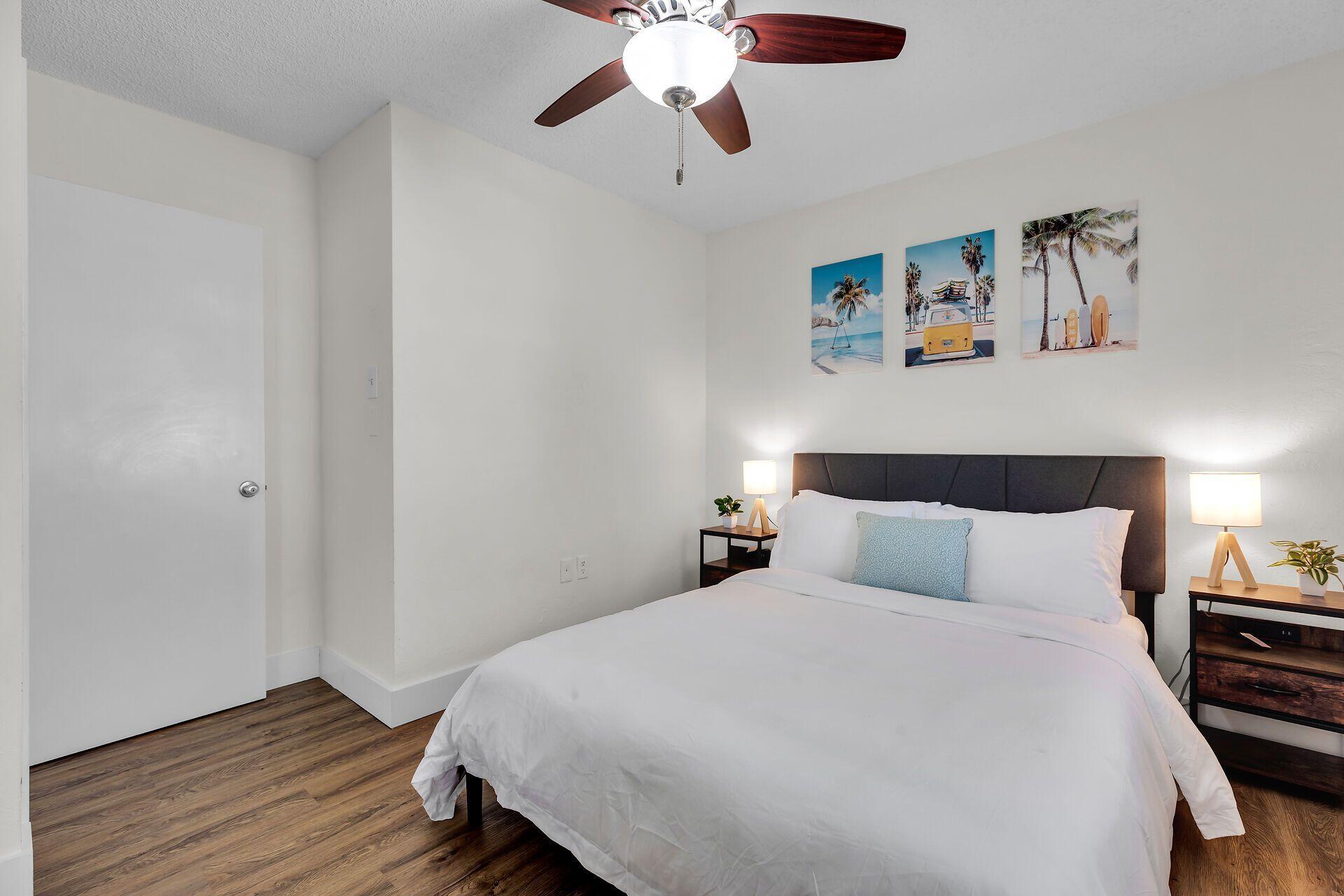 878 La Paloma Road Key Largo, FL 33037 - Photo 22 of 38 a bedroom with a bed and wooden floor