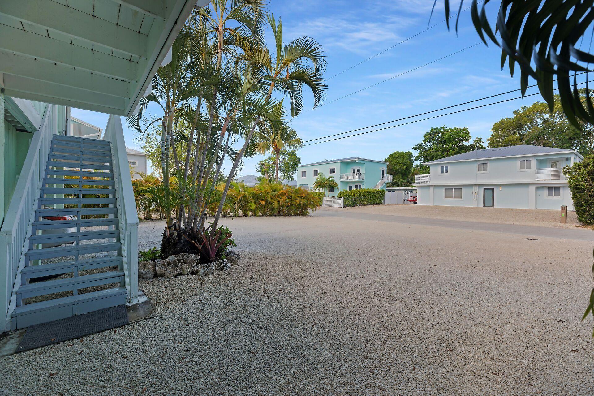 878 La Paloma Road Key Largo, FL 33037 - Photo 25 of 38 a view of a street with potted plants