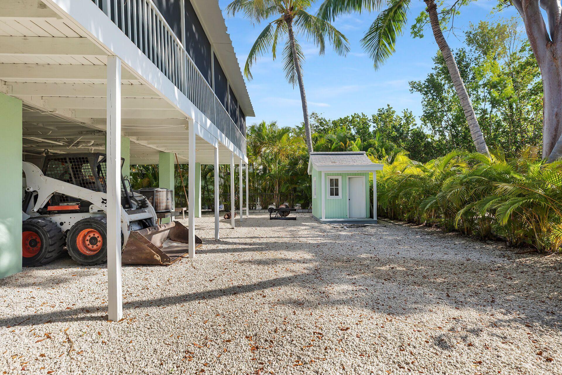 878 La Paloma Road Key Largo, FL 33037 - Photo 27 of 38 a view of a house with a patio