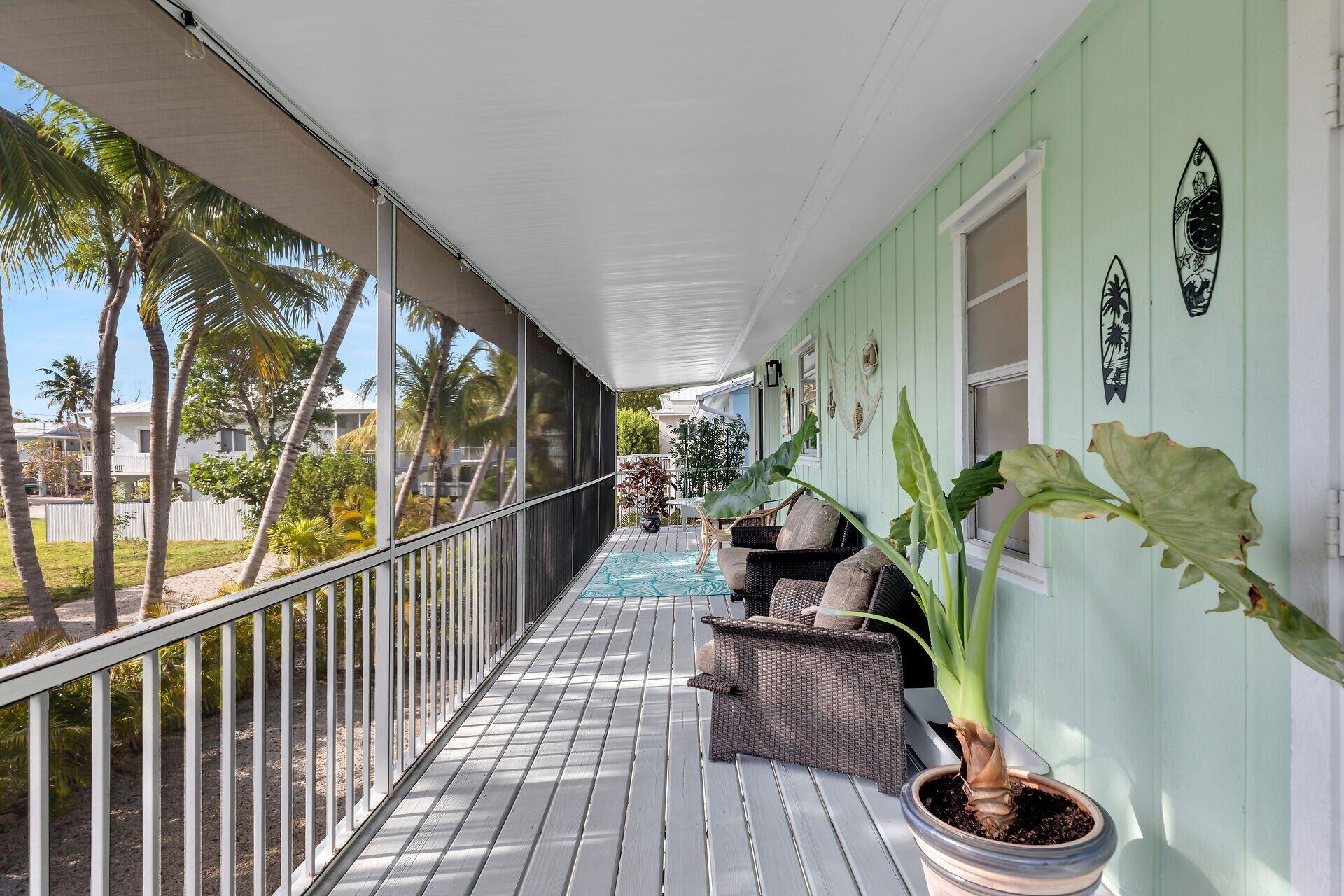 878 La Paloma Road Key Largo, FL 33037 - Photo 4 of 38 a living room with furniture and a floor to ceiling window