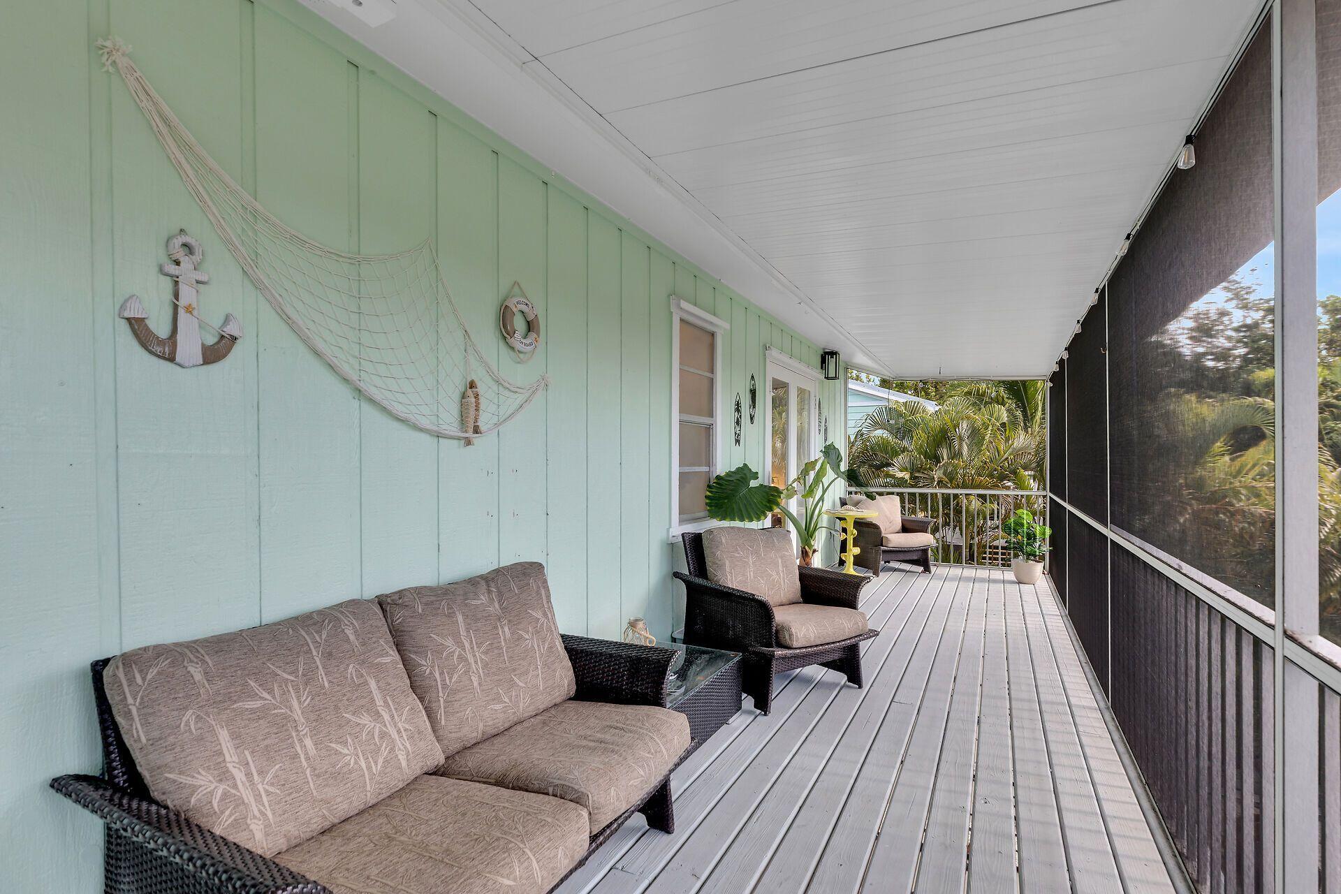 878 La Paloma Road Key Largo, FL 33037 - Photo 6 of 38 a living room with furniture and a flat screen tv