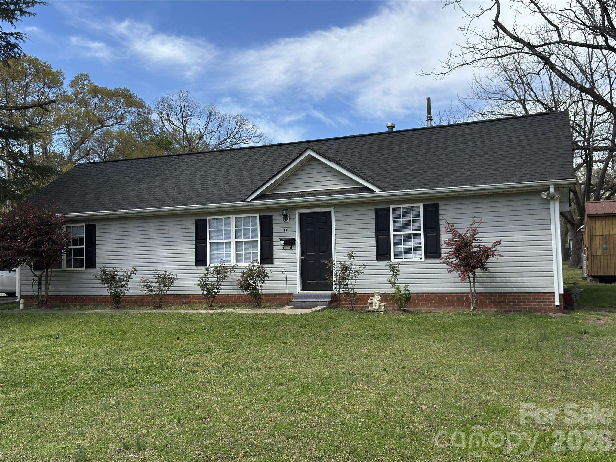 114 South Branch Street Monroe, NC 28112 - Photo 1 of 44 a front view of a house with a garden and yard
