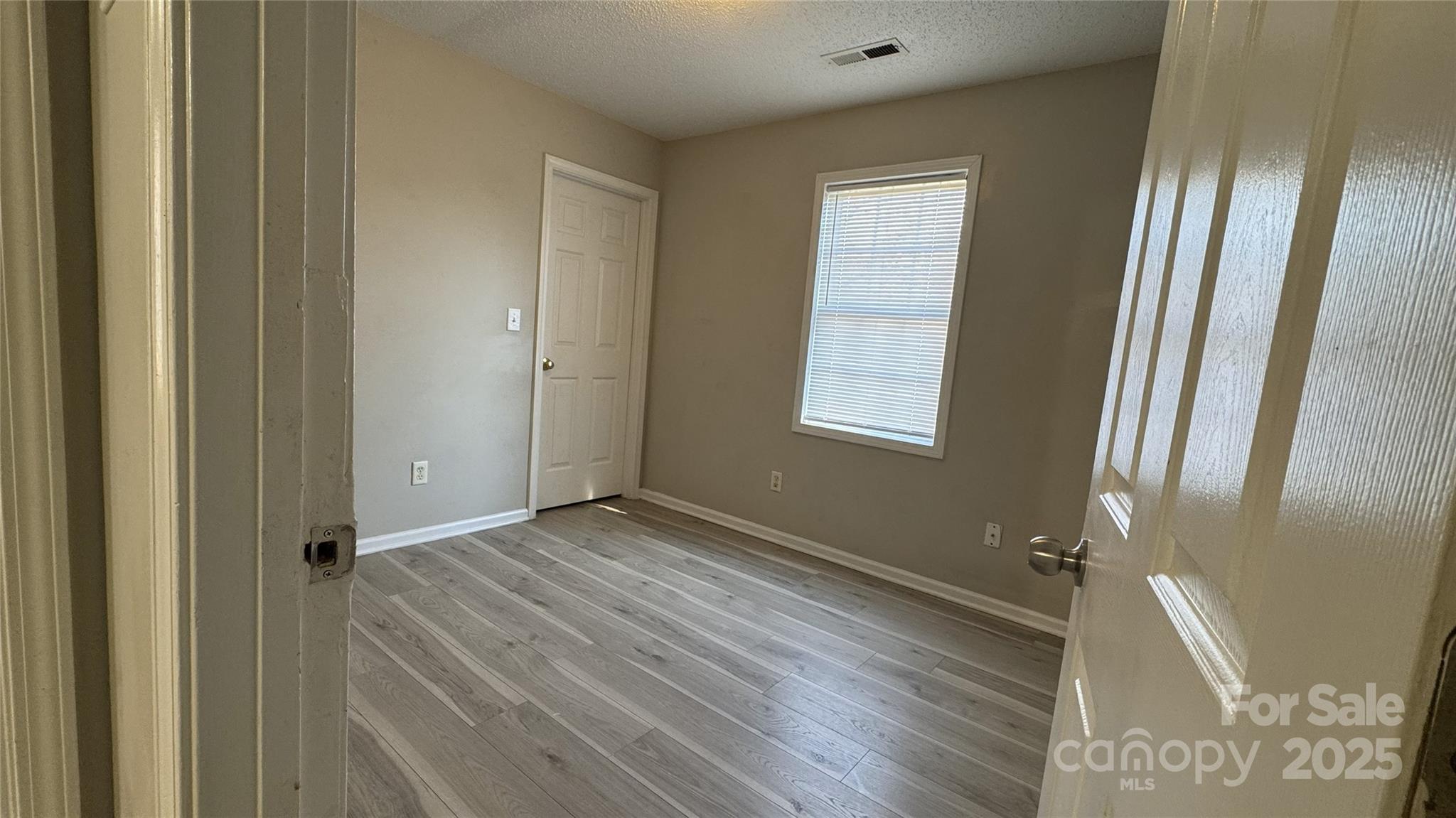 114 South Branch Street Monroe, NC 28112 - Photo 12 of 32 a view of an empty room with wooden floor and a window