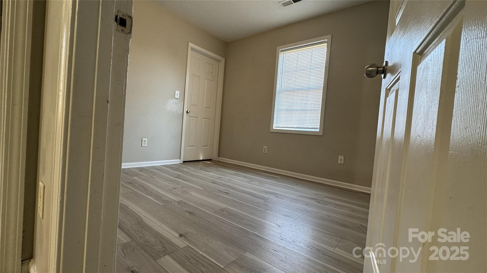 114 South Branch Street Monroe, NC 28112 - Photo 13 of 32 a view of an empty room with wooden floor and a window
