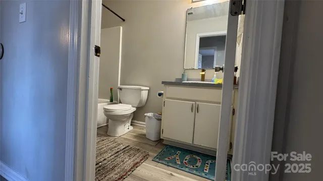 a bathroom with a toilet a sink and mirror