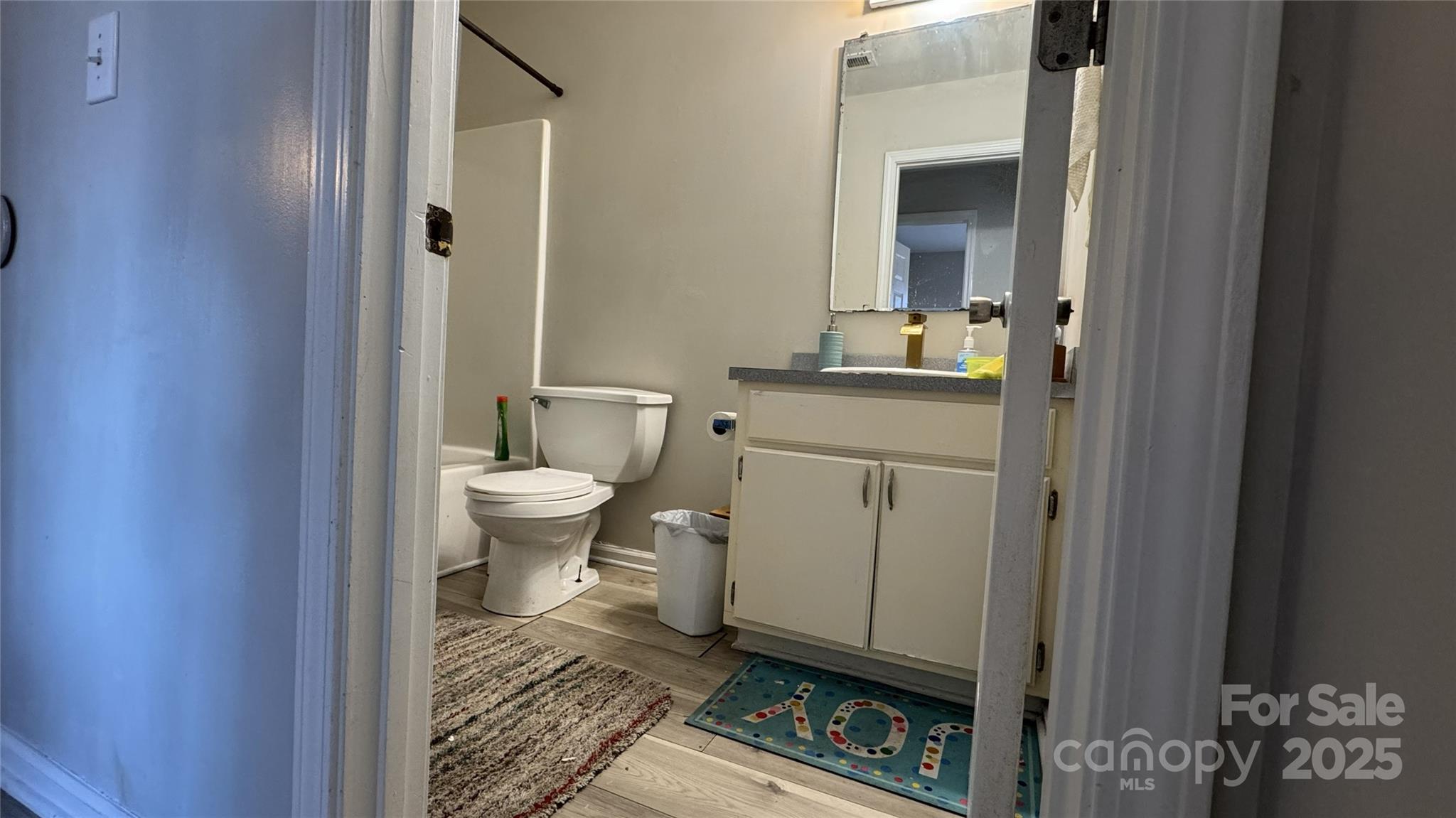 114 South Branch Street Monroe, NC 28112 - Photo 14 of 32 a bathroom with a toilet a sink and mirror