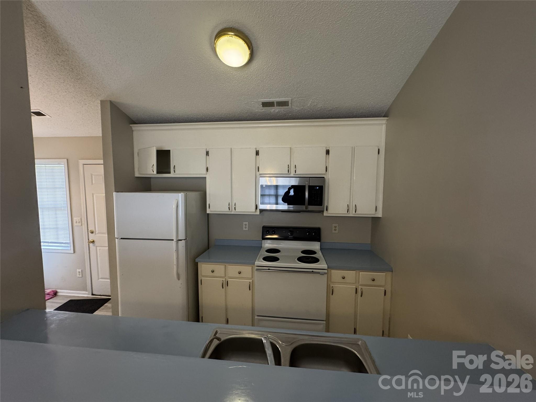 114 South Branch Street Monroe, NC 28112 - Photo 16 of 44 a kitchen with stainless steel appliances a refrigerator and a stove top oven