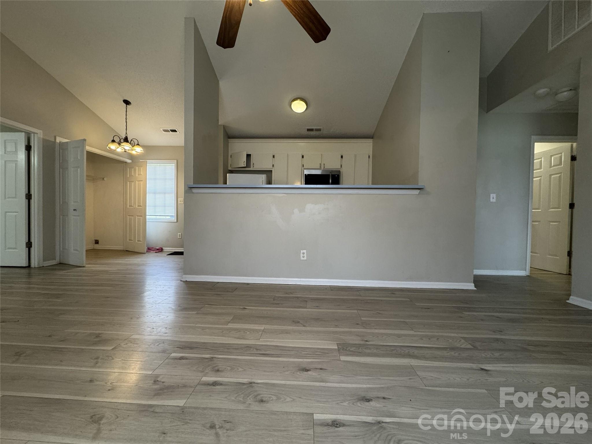 114 South Branch Street Monroe, NC 28112 - Photo 17 of 44 a view of a kitchen with kitchen island wooden floors and stainless steel appliances