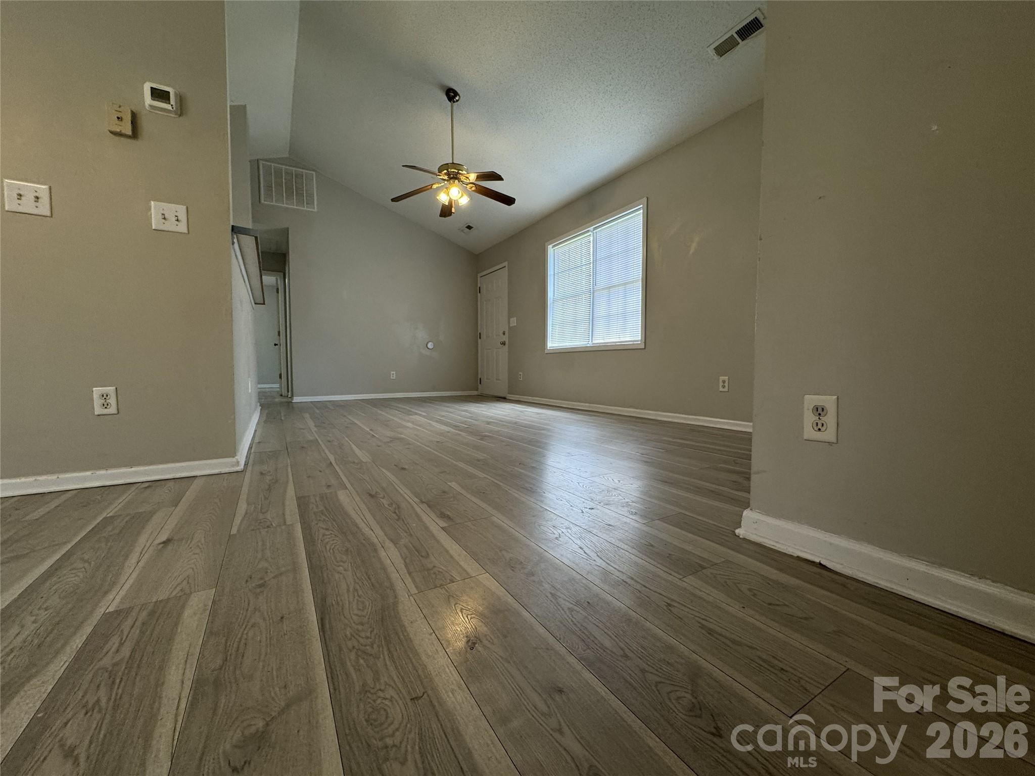 114 South Branch Street Monroe, NC 28112 - Photo 19 of 44 an empty room with wooden floor and windows