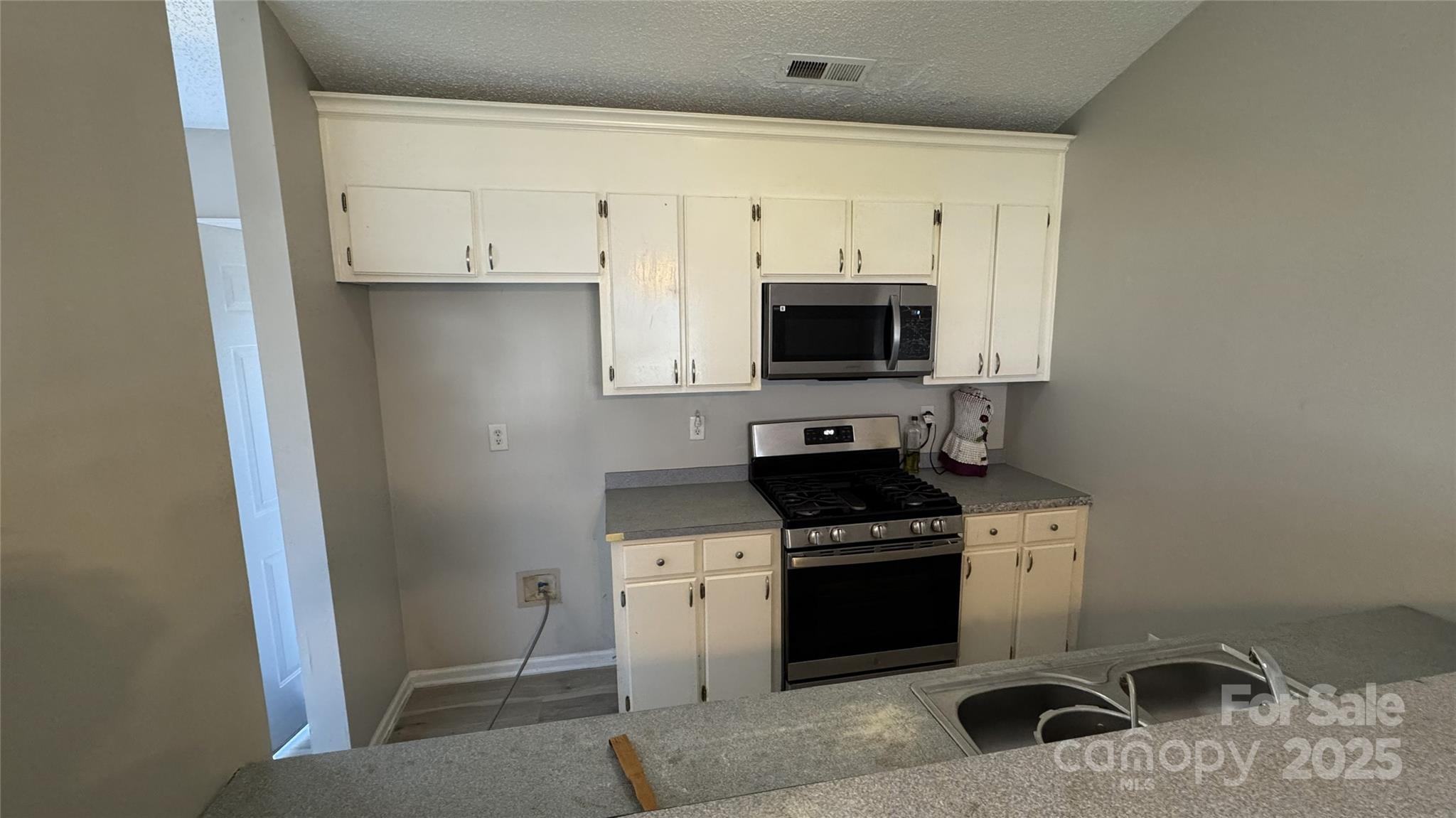 114 South Branch Street Monroe, NC 28112 - Photo 22 of 32 a kitchen with stainless steel appliances a stove a sink and a refrigerator