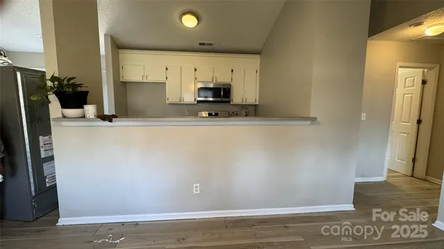 a view of a kitchen with a sink and a refrigerator