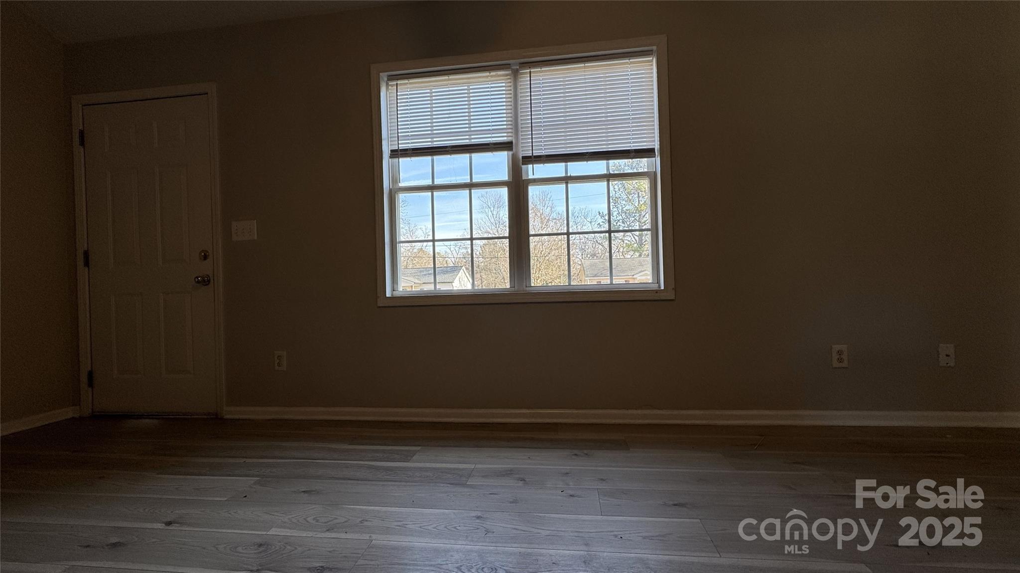 114 South Branch Street Monroe, NC 28112 - Photo 29 of 32 a view of an empty room with wooden floor and a window