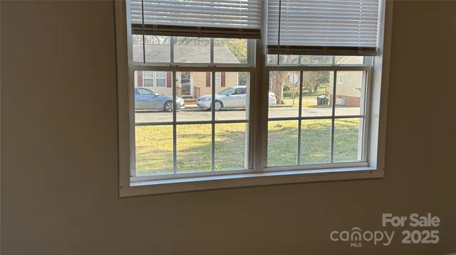 a view of a livingroom with an empty space and balcony