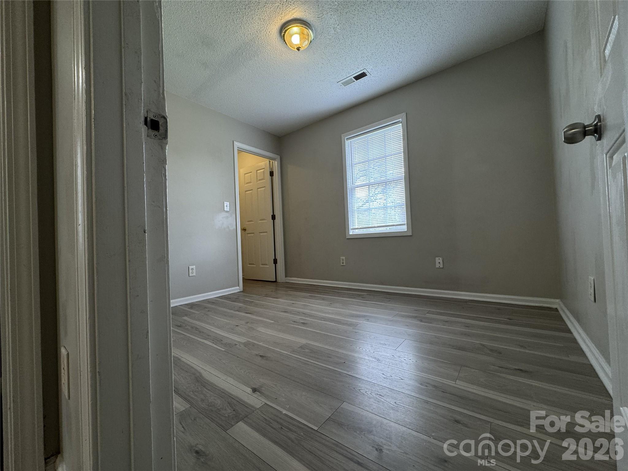 114 South Branch Street Monroe, NC 28112 - Photo 32 of 44 a view of an empty room with wooden floor and a window