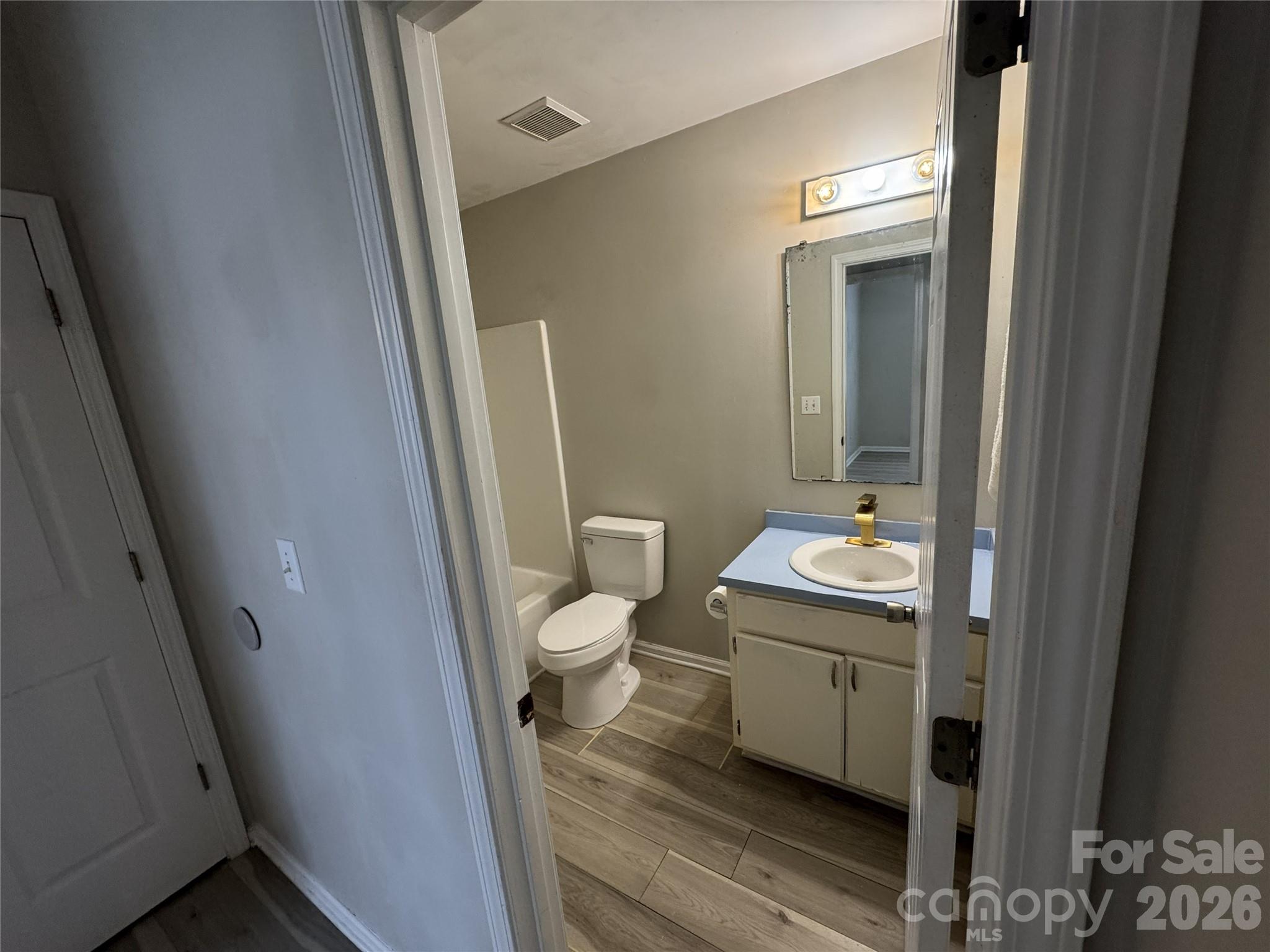 114 South Branch Street Monroe, NC 28112 - Photo 38 of 44 a bathroom with a toilet sink and mirror
