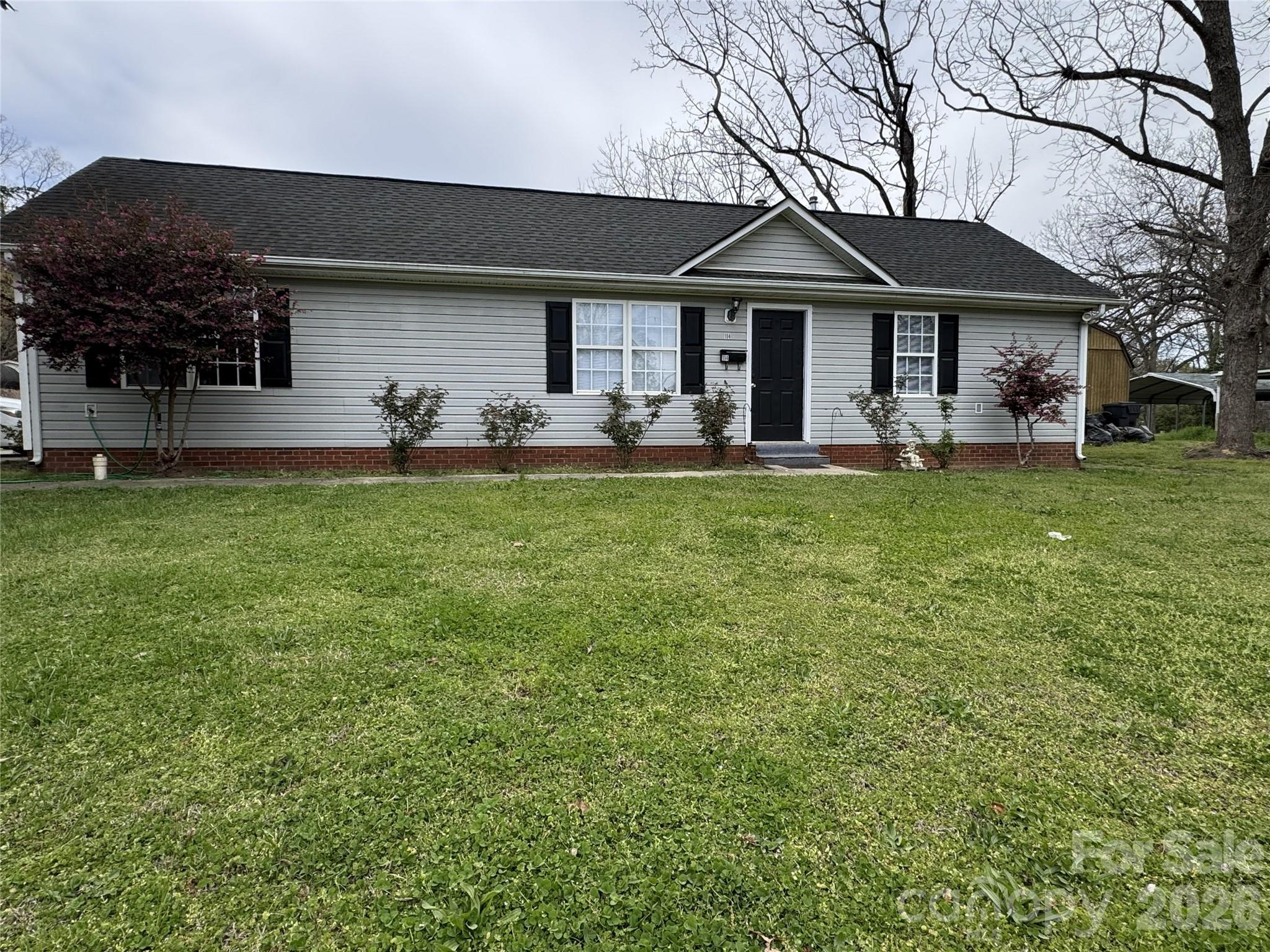 114 South Branch Street Monroe, NC 28112 - Photo 41 of 44 a front view of a house with a garden