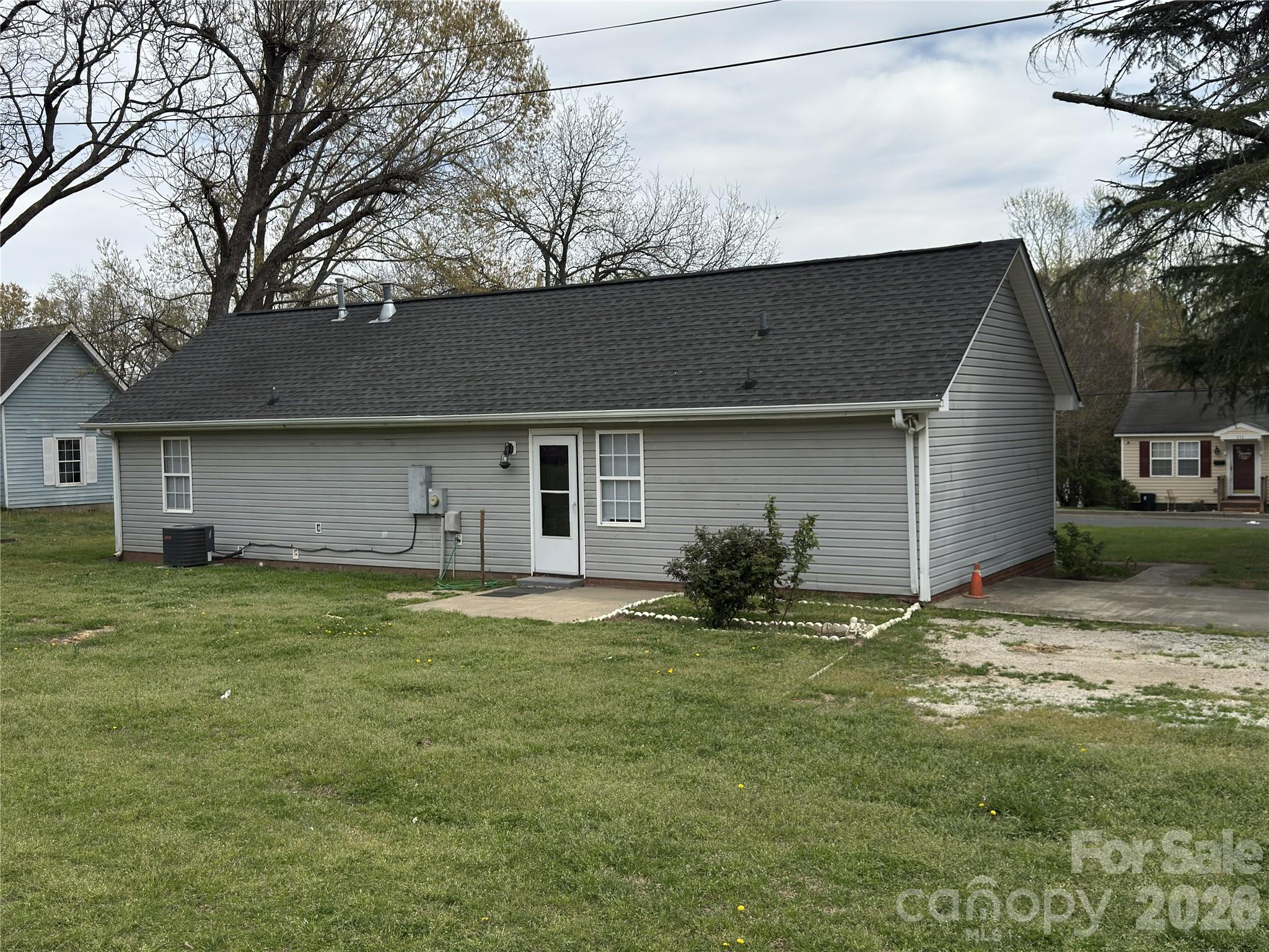114 South Branch Street Monroe, NC 28112 - Photo 44 of 44 a house that is sitting in the grass with large trees