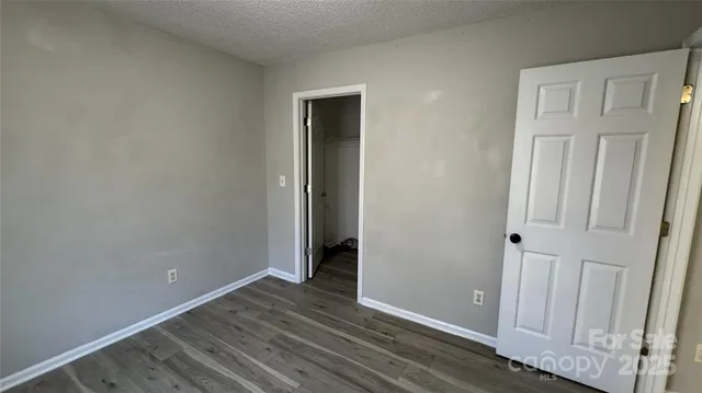 an empty room with wooden floor and closet