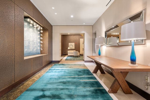 a dining hall with stainless steel appliances granite countertop a stove and a sink