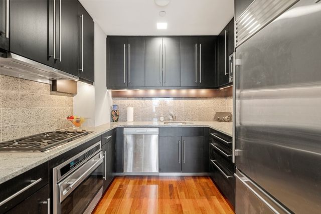 a kitchen with granite countertop stainless steel appliances and sink