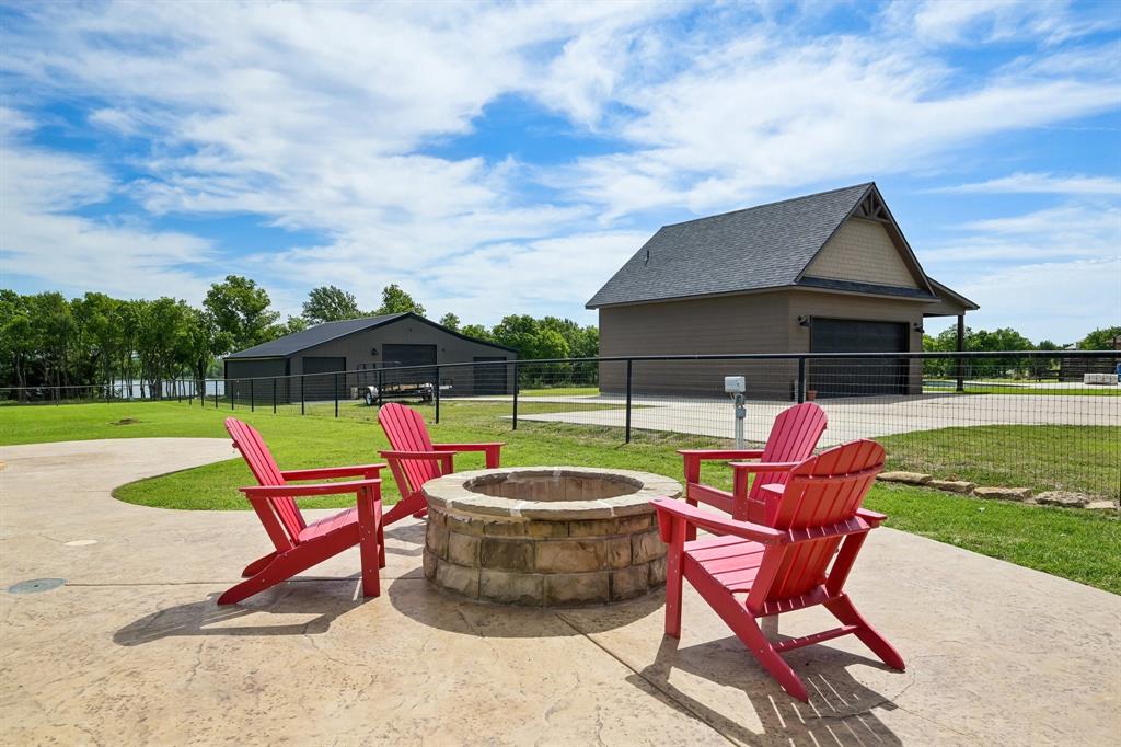 2085 Switzer Road Sanger, TX 76266 - Photo 27 of 39 Stamped concrete patio featuring a stone fire pit