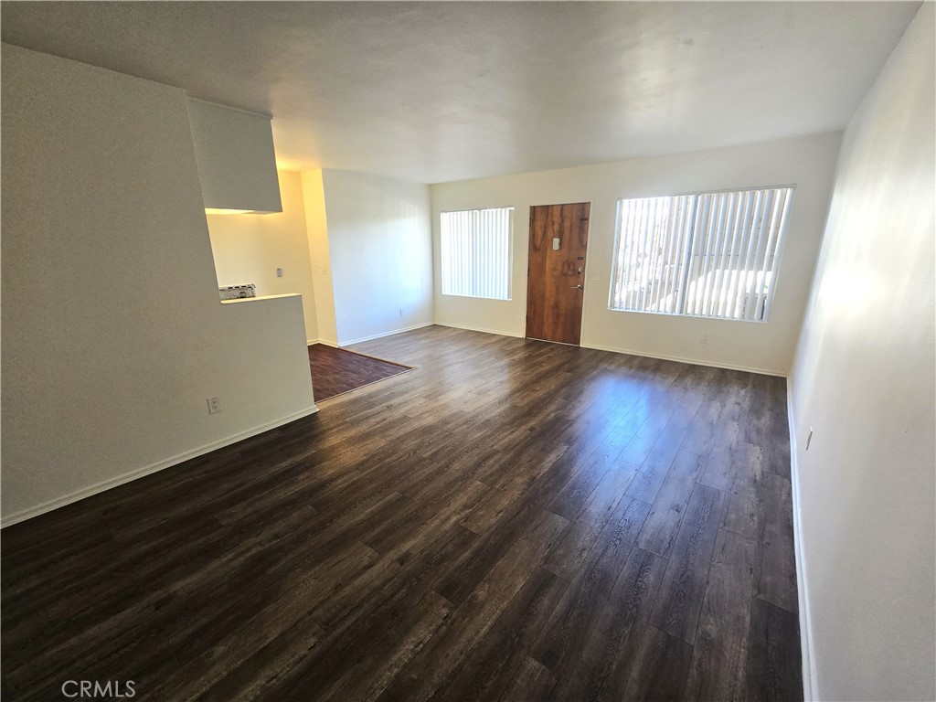 401 West Wilson Avenue, Unit 6 Glendale, CA 91203 - Photo 3 of 12 an empty room with wooden floor and windows