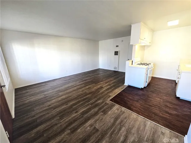a view of kitchen and empty room