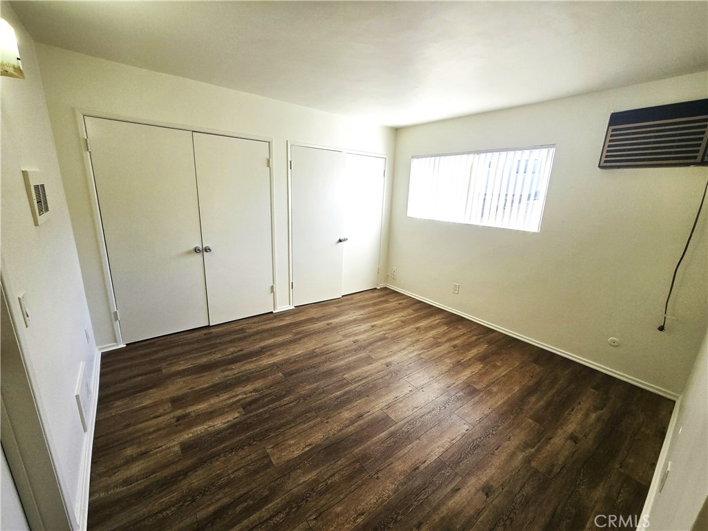 401 West Wilson Avenue, Unit 6 Glendale, CA 91203 - Photo 9 of 12 a view of a room with wooden floor and white walls