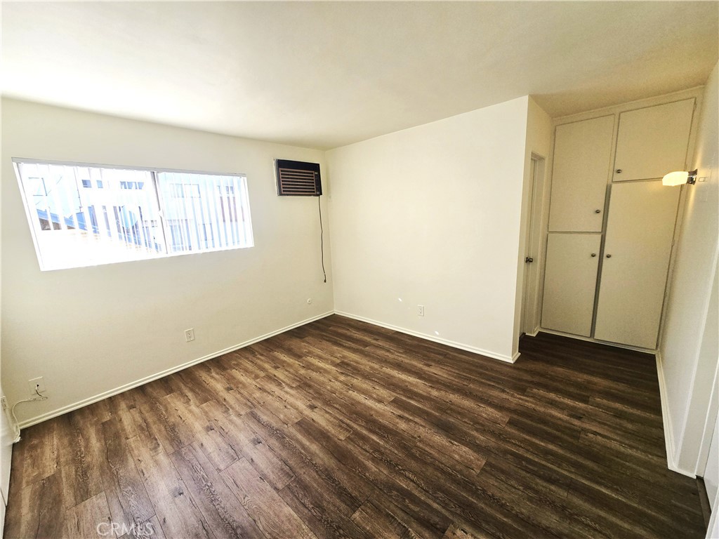 401 West Wilson Avenue, Unit 6 Glendale, CA 91203 - Photo 10 of 12 an empty room with wooden floor and windows