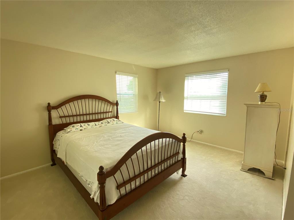 1500 Gay Road, Unit 18A Winter Park, FL 32789 - Photo 11 of 21 a bed sitting in a bedroom next to a window