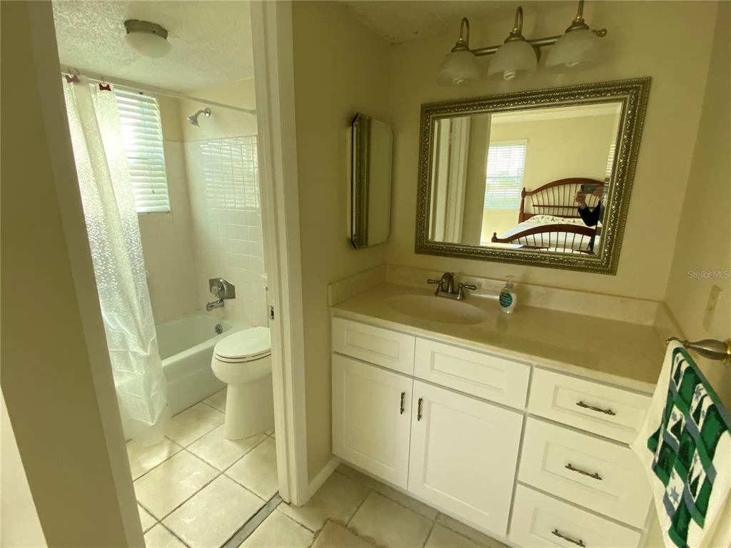 1500 Gay Road, Unit 18A Winter Park, FL 32789 - Photo 12 of 21 a bathroom with a granite countertop sink toilet and shower