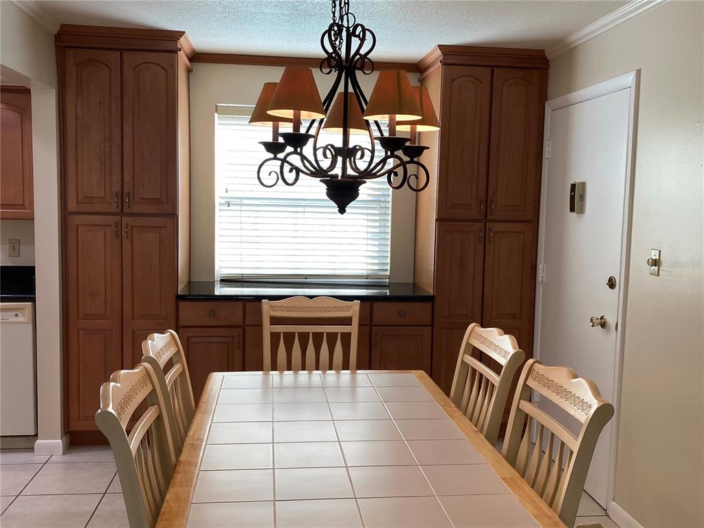 1500 Gay Road, Unit 18A Winter Park, FL 32789 - Photo 6 of 21 a bedroom with a bed and a chandelier