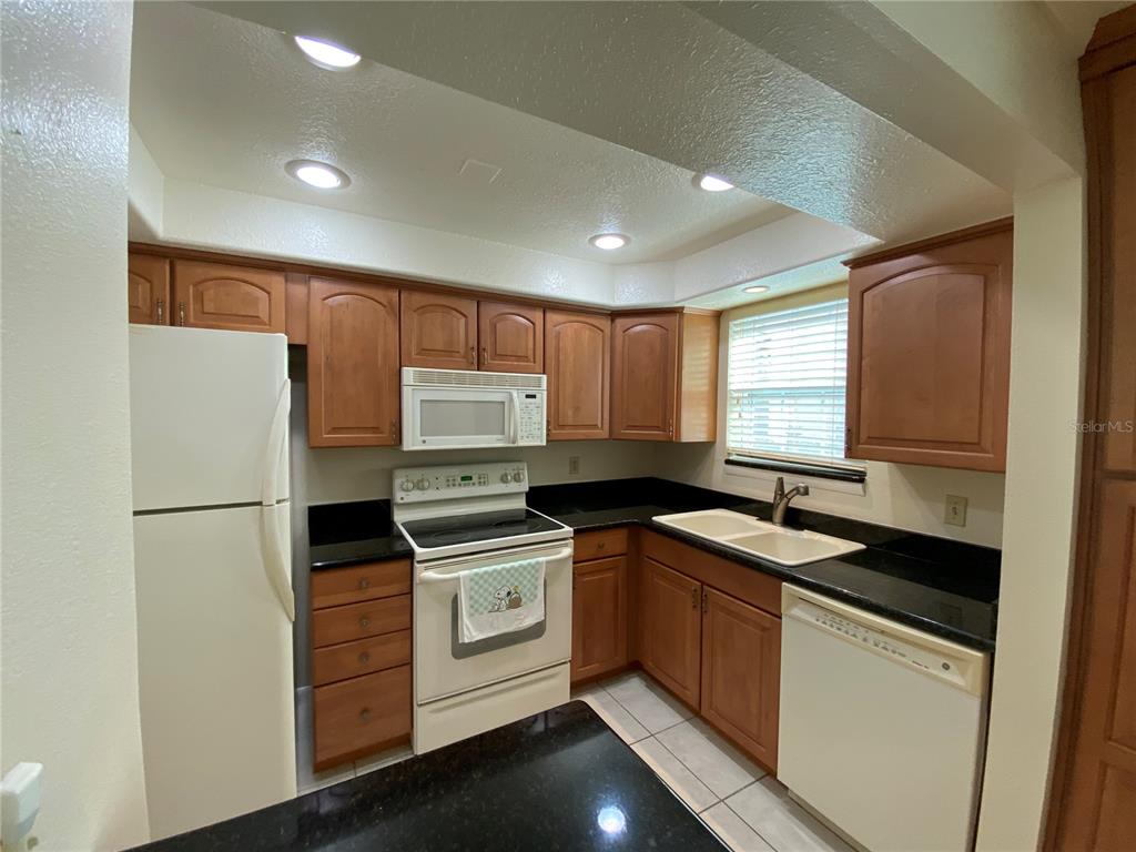 1500 Gay Road, Unit 18A Winter Park, FL 32789 - Photo 7 of 21 a kitchen with a sink stove and refrigerator