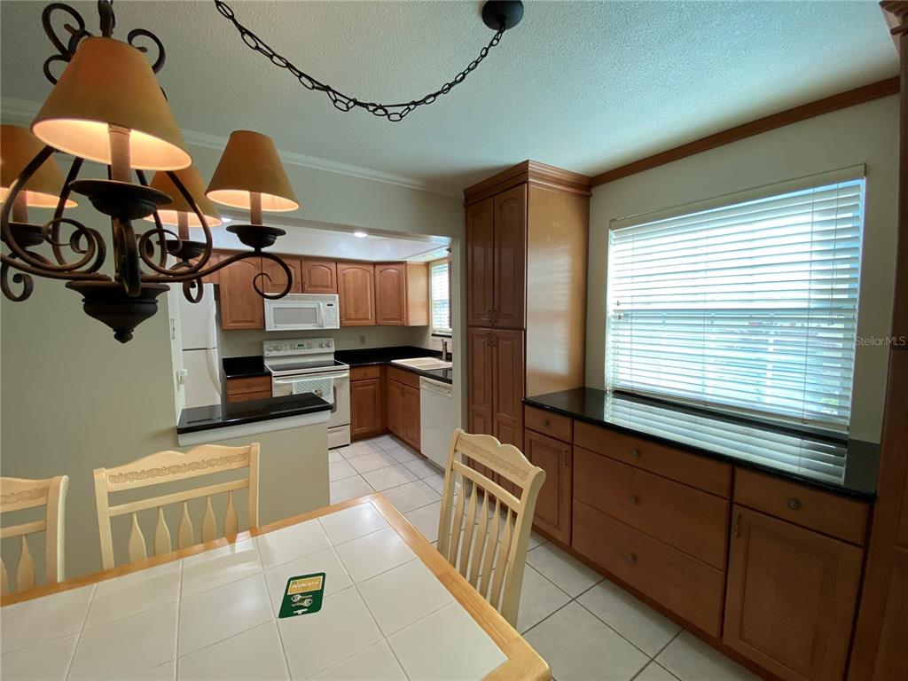 1500 Gay Road, Unit 18A Winter Park, FL 32789 - Photo 9 of 21 a kitchen with stainless steel appliances granite countertop a sink and cabinets
