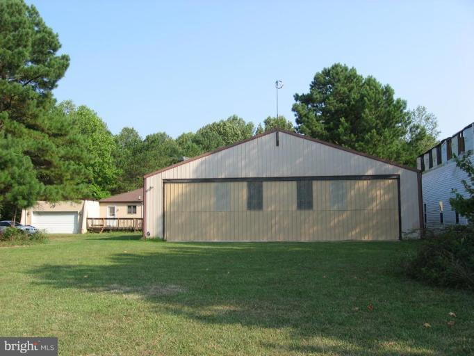 885 Crystal Rock Road Lusby, MD 20657 - Photo 18 of 18 a view of a back yard of the house with green space