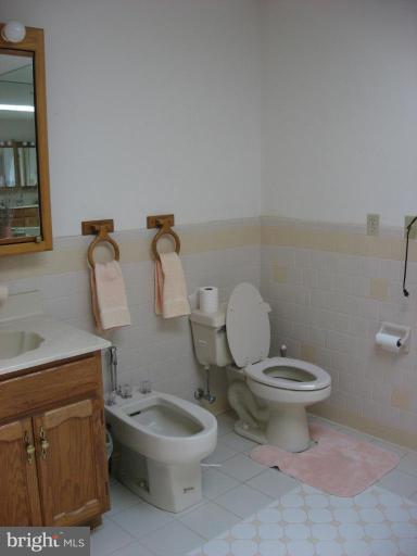 885 Crystal Rock Road Lusby, MD 20657 - Photo 8 of 18 a white toilet sitting next to a bathroom sink