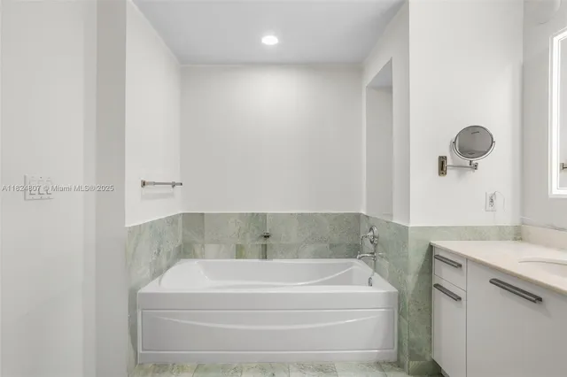 a bathroom with a bathtub and a sink