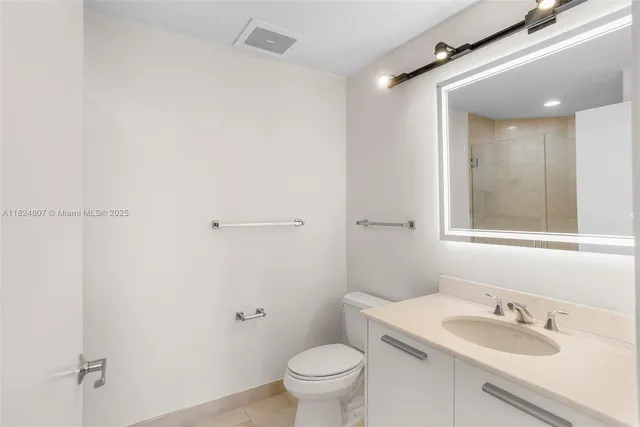 a bathroom with a sink toilet and vanity