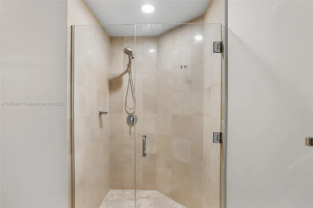 a bathroom with a glass shower door