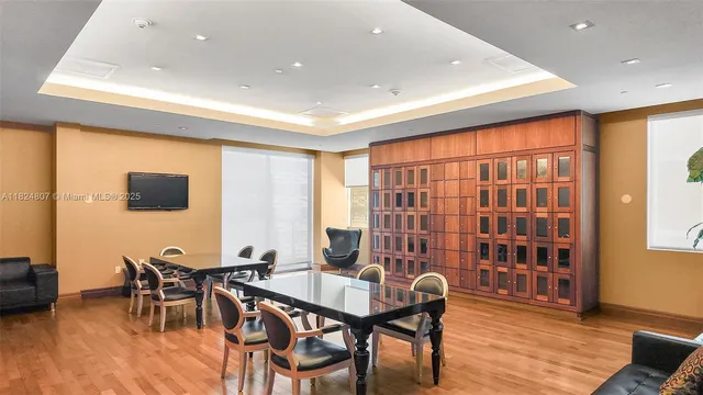 a view of a a dining room with furniture window and wooden floor