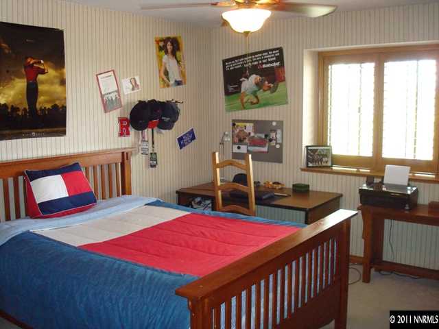 3342 Corey Drive Reno, NV 89509 - Photo 7 of 13 a bedroom with a bed and a chandelier