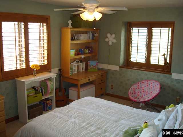 3342 Corey Drive Reno, NV 89509 - Photo 9 of 13 a bedroom with a bed and a chandelier