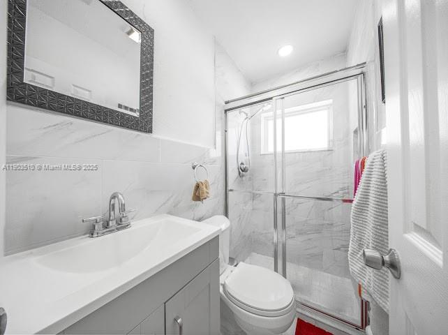 16125 Northwest 28th Place Miami Gardens, FL 33054 - Photo 16 of 25 a bathroom with a sink a toilet and shower