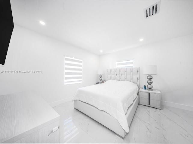 16125 Northwest 28th Place Miami Gardens, FL 33054 - Photo 18 of 25 a bedroom with a bed and a table