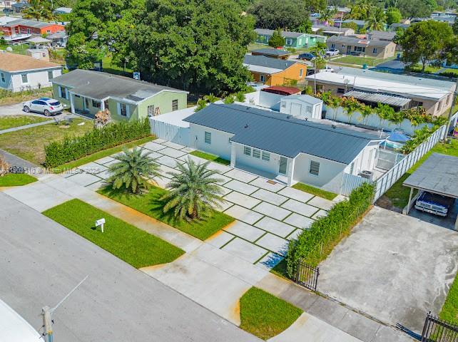 16125 Northwest 28th Place Miami Gardens, FL 33054 - Photo 6 of 25 an aerial view of a house with a yard and lake view