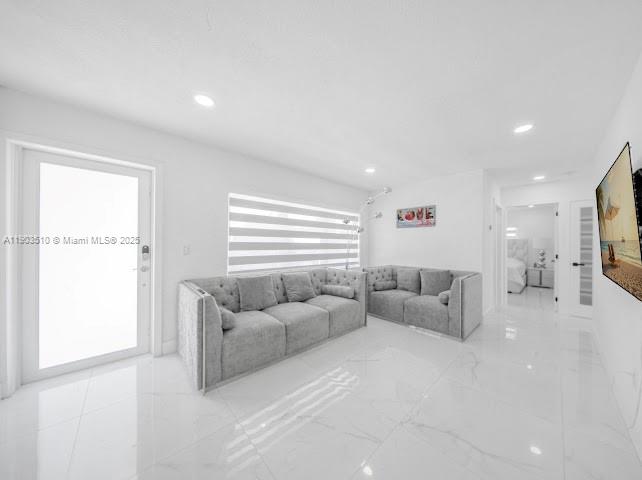 16125 Northwest 28th Place Miami Gardens, FL 33054 - Photo 8 of 25 a living room with furniture and a large window