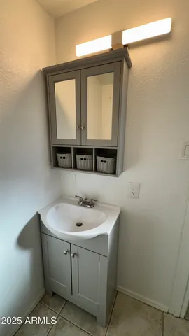 a bathroom with a sink a toilet and mirror