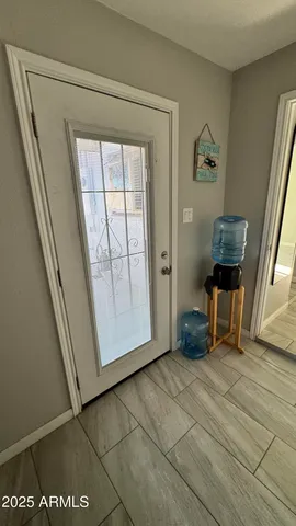 a view of an entryway with wooden floor