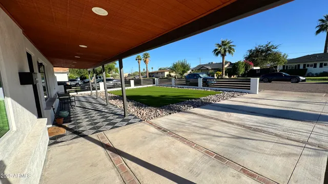 a view of a porch with furniture and a yard