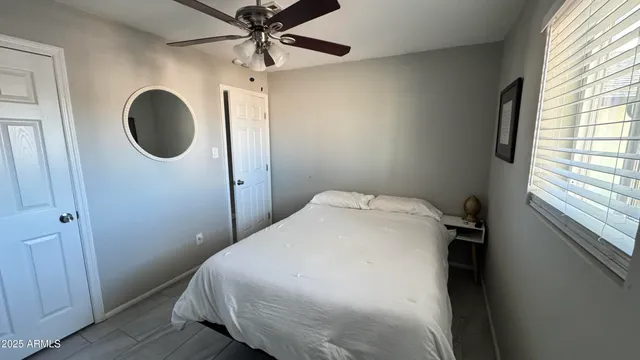 a bedroom with a bed and a mirror